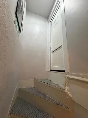 a small bathroom with a window and stairs in it at Grey House Apartments B Block in Istanbul