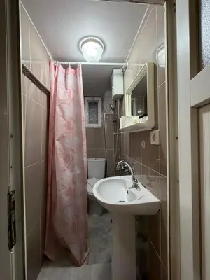 a bathroom with a sink and a shower curtain at Grey House Apartments B Block in Istanbul