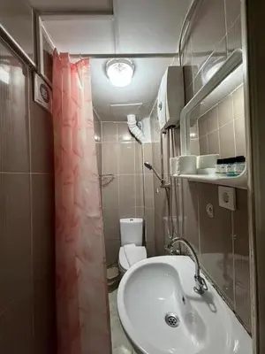 a small bathroom with a sink and a toilet at Grey House Apartments B Block in Istanbul