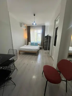 a room with a bed and two chairs and a table at Şişli Suites - Room25 in Istanbul