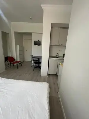 a room with a bed and a kitchen and a table at Şişli Suites - Room25 in Istanbul