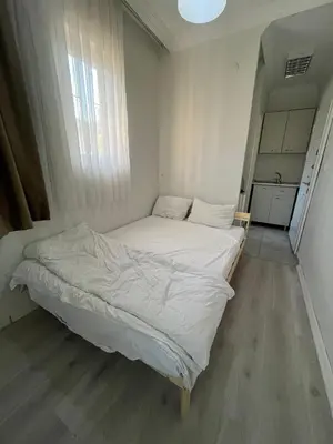 a small bedroom with a white bed in it at Şişli Suites - Room32 in Istanbul