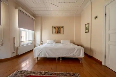 a bedroom with a bed with white sheets and a window at House with Terrace in Sultanahmet in Istanbul
