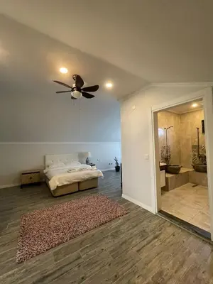 a bedroom with a bed with a ceiling fan and a mirror at Villa akça in Kartepe