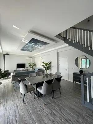 a living room with a table and chairs and a couch at Villa akça in Kartepe