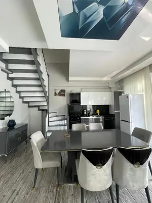 a kitchen with a table and chairs and a staircase at Villa akça in Kartepe
