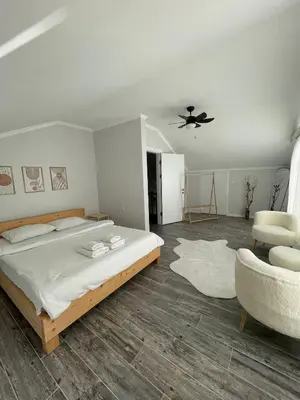 a bedroom with a bed and a ceiling fan at Villa akça in Kartepe