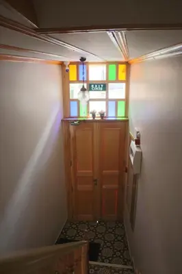 a hallway with a door with stained glass at 3 Floor History Mansion in Istanbul
