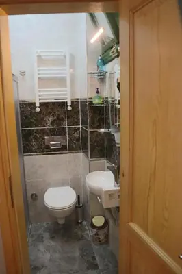 a small bathroom with a toilet and a sink at 3 Floor History Mansion in Istanbul