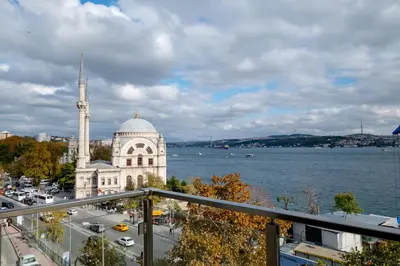 a building with a mosque next to a body of water at Bosphorus View with 3 Bedrooms and 2 Bathrooms in Istanbul