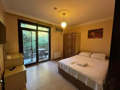 a bedroom with a bed and a large window at CANPOLAT Sapanca Hotel in Sapanca