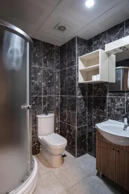 a bathroom with a toilet and a sink and a shower at CANPOLAT Sapanca Hotel in Sapanca