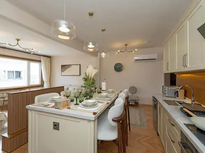a kitchen with a large white island in a room at sevim suites Nişantaşı Rumeli in Istanbul