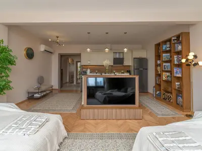 a living room with a large flat screen tv at sevim suites Nişantaşı Rumeli in Istanbul