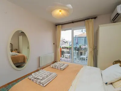 a bedroom with a bed and a mirror and a balcony at sevim suites Nişantaşı Rumeli in Istanbul