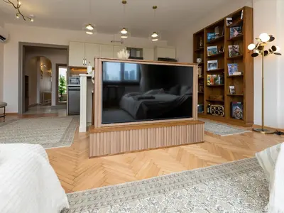 a large flat screen tv in a living room at sevim suites Nişantaşı Rumeli in Istanbul