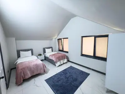two beds in a room with two windows at Adesa View Villas in Sapanca