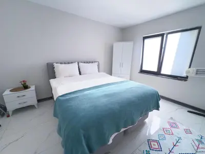 a white bedroom with a bed with a blue blanket at Adesa View Villas in Sapanca