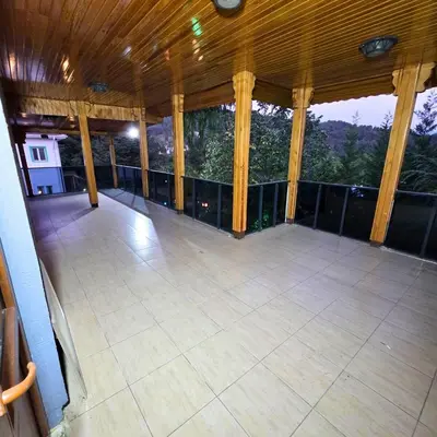 a large screened porch with a view of the mountains at Uludag Nefes Echoes by the Woods in Uludag