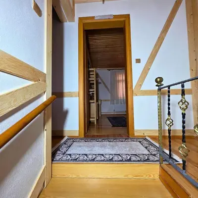a hallway with a door leading into a room with a rug at Uludag Nefes Echoes by the Woods in Uludag