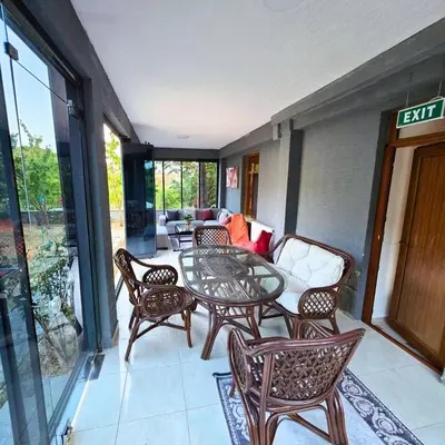 a patio with a table and chairs and a couch at Uludag Nefes Echoes by the Woods in Uludag
