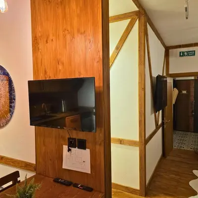 a flat screen tv on a wall in a room at Uludag Zirve Garden - BBQ Jacuzzi