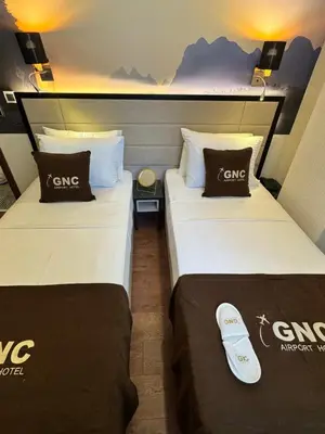 two beds sitting next to each other in a room at Gnc Airport Hotel in Arnavutköy