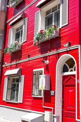 a red building with a red door and windows at Balat Side Apart in Istanbul