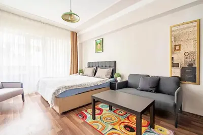 a bedroom with a bed and a couch and a table at 1st Floor Historic Flat in Old Istanbul in Istanbul
