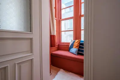 a window seat in a room with a red bench at Urban Balcony Suite - Close to Taksim in Istanbul