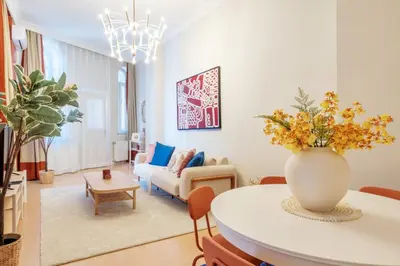 a living room with a vase of flowers on a table at Urban Balcony Suite - Close to Taksim in Istanbul