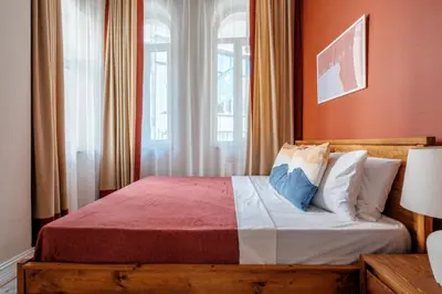 a bedroom with a wooden bed with a window at Urban Balcony Suite - Close to Taksim in Istanbul