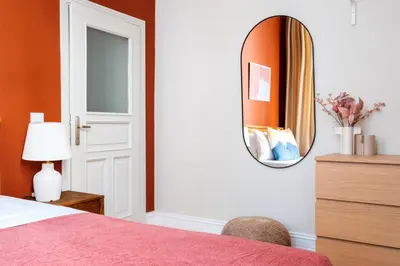 a bedroom with a bed and a mirror on the wall at Urban Balcony Suite - Close to Taksim in Istanbul