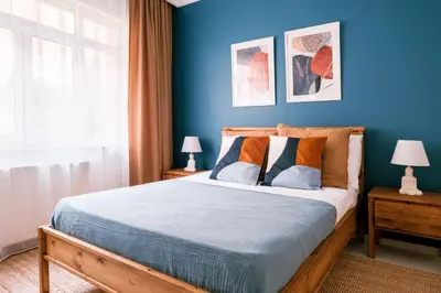 a bedroom with a bed with a blue wall at Stylish Flat w Balcony – 5 Mins from Taksim Square in Istanbul