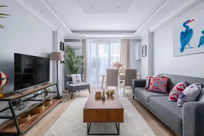 a living room with a couch and a table at Newly Built in Sisli • Fast WiFi • Elevator in Istanbul