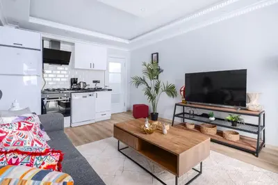 a living room with a tv and a coffee table at Newly Built in Sisli • Fast WiFi • Elevator in Istanbul