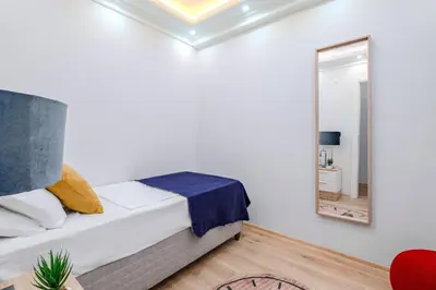 a bedroom with a bed and a mirror at Newly Built in Sisli • Fast WiFi • Elevator in Istanbul