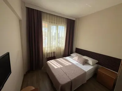 a small bedroom with a bed and a window at Otel Parpali in Istanbul