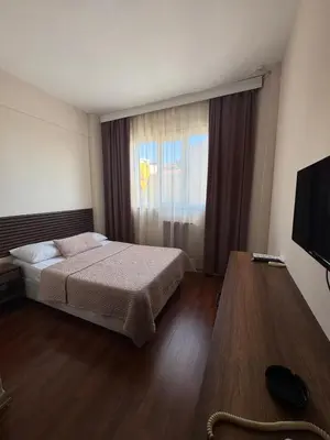 a hotel room with a bed and a window at Otel Parpali in Istanbul