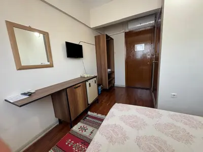 a bedroom with a desk and a mirror and a bed at Otel Parpali in Istanbul