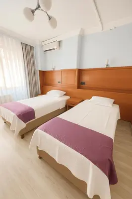 two beds in a hotel room with two bedsvisor at Ferah Otel in Gebze
