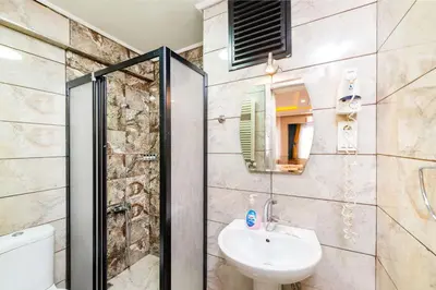 a bathroom with a shower and a sink and a toilet at Kadirga Studios in Istanbul