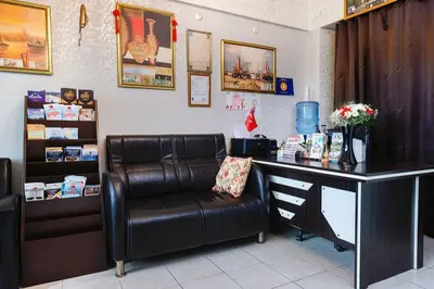 a salon with a leather chair and a desk at Kadirga Studios in Istanbul