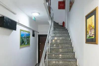 a staircase in a building with paintings on the walls at Kadirga Studios in Istanbul