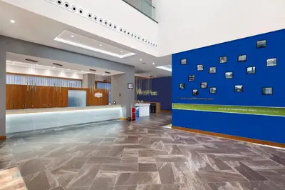 a lobby with a blue wall with pictures on it at Hampton By Hilton Kocaeli Symbol in Kocaeli