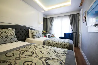 a hotel room with two beds and a window at Antusa Palace Hotel & Spa in Istanbul
