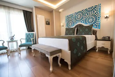 a bedroom with a bed with a blue and white wall at Antusa Palace Hotel & Spa in Istanbul