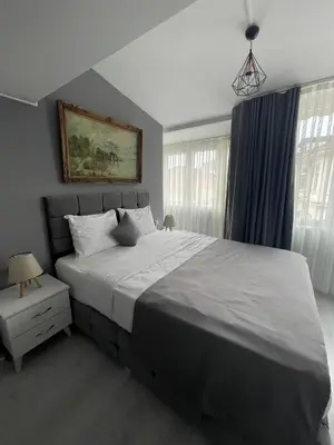 a bedroom with a large white bed and windows at Oldmile Palace Hotel in Istanbul