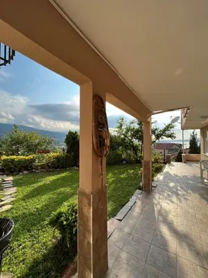 a house with a patio with a view of a yard at bahçeli ve göl manzaralı ev in Sapanca