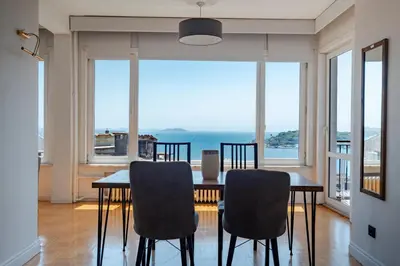 a dining room with a table and chairs and a large window at Bosphorus View with 5 Bedrooms and Elevator in Istanbul